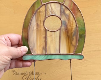 Handcrafted stained glass fairy door suncatcher in light brown and green, whimsical garden art, unique home decor, magical plant stake