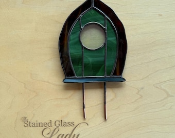 Handcrafted stained glass fairy door in dark green and brown, unique garden art, whimsical home decor, magical plant stake