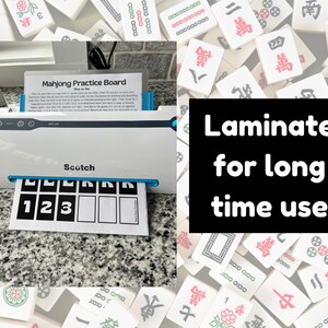 May include: A white Scotch laminator with a blue trim is shown, with a printed Mahjong practice board emerging. The text "Laminate for long time use" is displayed on a black background. The background is filled with Mahjong tiles.