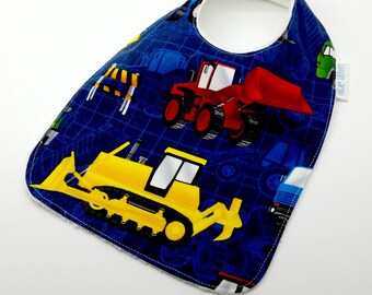 Baby Bib - Construction Vehicles on Blue Cotton Fabric, with optional Personalised Label, Bamboo Toweling backed, Snap Fastened, Adjustable.