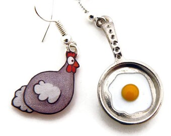 Mismatched chicken and egg earrings on the fried, humorous jewel