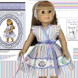 May include: A doll wearing a blue and rainbow striped dress with a white ruffle trim. The dress has a matching sash and is tied at the waist. The doll is also wearing a white headband.