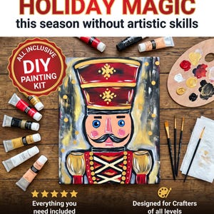 May include: A DIY painting kit featuring a canvas with a painted nutcracker, multiple tubes of acrylic paint, a wooden palette with paint dabs, three paintbrushes, and a paper towel. Text includes "How I'm creating my HOLIDAY MAGIC" and "ALL INCLUSIVE".