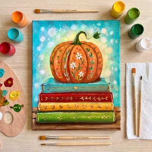 May include: An art kit featuring a canvas painting of an orange pumpkin with white floral designs resting on a stack of three books. The kit includes paint pots in various colours, four paintbrushes, a wooden palette, and a paper towel. Text reads: Are you a beginner -- no worries this is for you! Once Upon a Pumpkin -- Art Kit available at Robin’s ARt and Crafts. You get your canvas, supply list, instructions, paint, brushes, palette and paper towel.