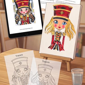 May include: A digital tablet displaying a Nutcracker painting guide, a printed supply list and instructions, two line-art tracer sheets, a canvas on a wooden easel, a glass of water, and a wooden paint palette with brushes and acrylic paint colors.
