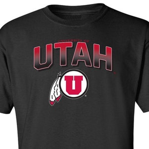May include: Black t-shirt with a red and white University of Utah logo. The logo features the word "UTAH" in a red gradient and a white "U" inside a red circle.