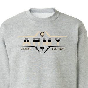 May include: A gray sweatshirt with a black and gold graphic of the word "ARMY" with a football helmet and the text "GO ARMY. BEAT NAVY."