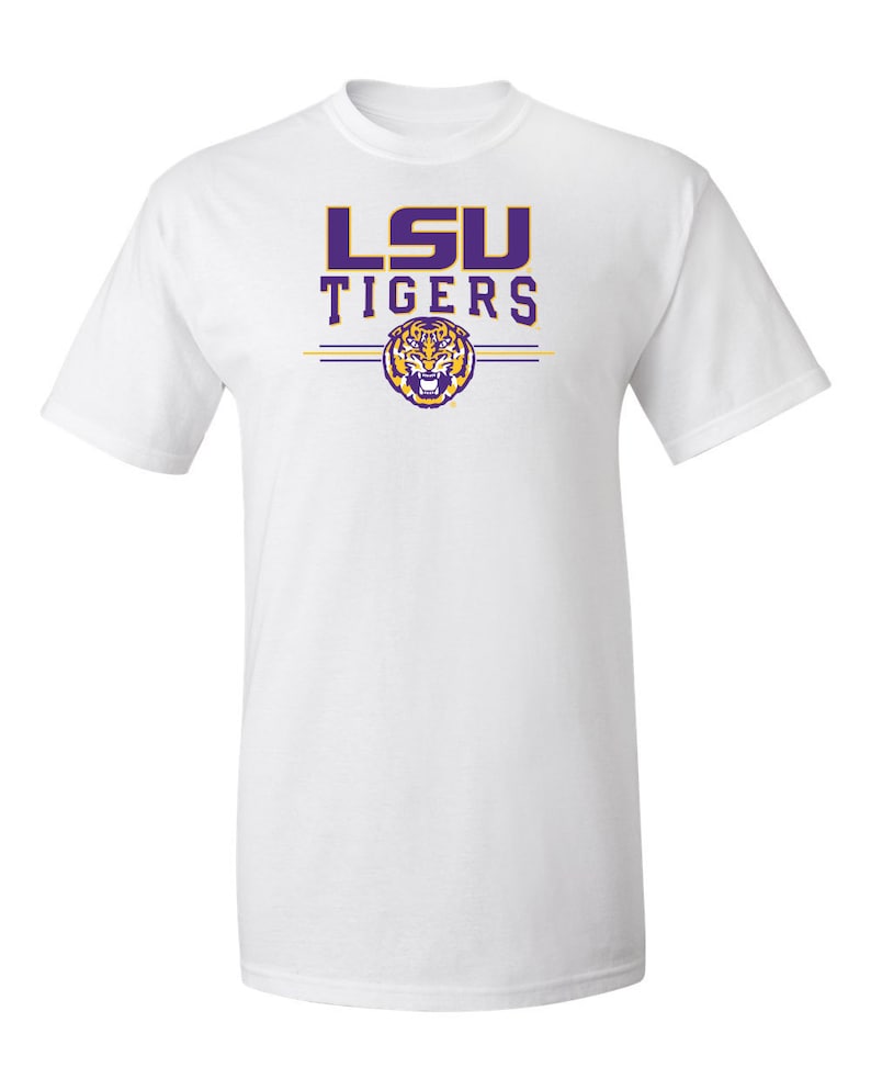 Puede incluir: Camiseta blanca con un logotipo morado de LSU Tigers y un gr&aacute;fico de cabeza de tigre.