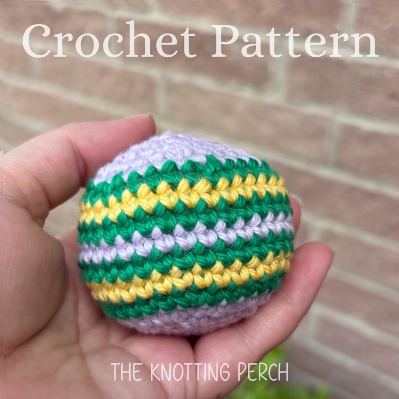 May include: A spherical crochet object featuring horizontal stripes in light purple, vibrant green, and bright yellow yarn. The text Crochet Pattern and The Knotting Perch are visible in white lettering against the background of the image.