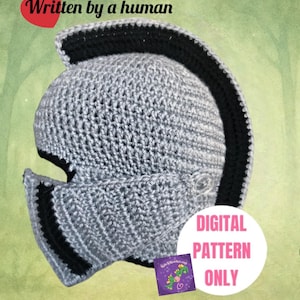May include: A gray crocheted helmet with a black mohawk-style crest and a movable visor. The text "Written by a human" appears in the top left corner, and a white circle contains the pink text "DIGITAL PATTERN ONLY" with a small logo below.