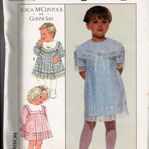 May include: A Simplicity sewing pattern envelope 8885 for a Jessica McClintock for Gunne Sax dress in size 2. The cover features illustrations and a photograph of a child wearing a light blue dress with a wide lace-trimmed collar and ribbon.