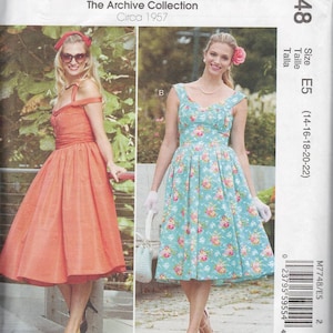 May include: A vintage sewing pattern for a dress, McCall's pattern number M7748, size E5 (14-16-18-20-22), circa 1957. The pattern shows two models wearing different versions of the dress, one in a solid coral color and the other in a floral print.