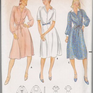 May include: Vintage Butterick sewing pattern 5879, size 16, featuring illustrations of three button-down dresses with belts. The dresses are in pink, white, and blue floral patterns. The pattern includes front and back views.