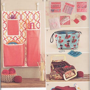 May include: A Simplicity sewing pattern for making various knitting and crocheting storage bags. The pattern includes instructions for a wall-mounted organizer with pockets, a tote bag with a fox print, a basket-style bag with a floral print, and a roll-up case for needles. The pattern number is 1079.