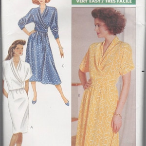 May include: Butterick sewing pattern 4085, featuring three dress designs. The dresses include a wrap-style design in blue with white polka dots, a white dress, and a yellow dress with a leaf pattern. The pattern is rated Very Easy.