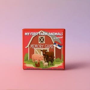 May include: A red box featuring a barn illustration with farm animals and the text "MY FIRST FARM ANIMALS in Serbian! MEMORY GAME". The box includes Cyrillic & Latinica, simple pronunciations, and English translations.