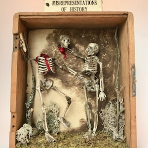 MISREPRESENTATIONS OF HISTORY - Original Assemblage Art - A Skeleton Beheads Another - Cigar Shadowbox - Natural Materials - Antique Print