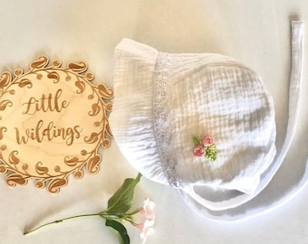 Handmade white baby bonnet white cotton inside with white trim, also embroidered flowers on the side. Last 2 left.