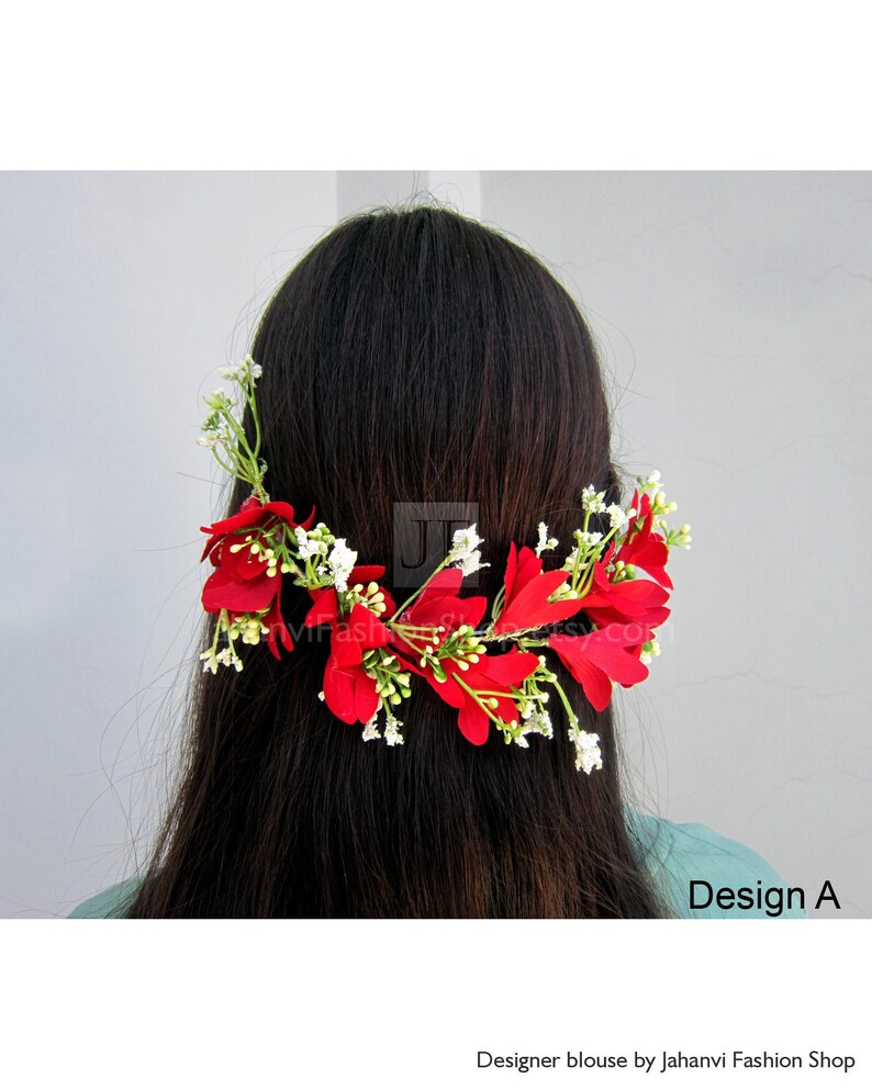 May include: A floral hair accessory featuring vibrant red petals and small white blossoms. The design, labeled "Design A," is arranged on a green stem, creating a natural and elegant look. The accessory is set against a neutral background.