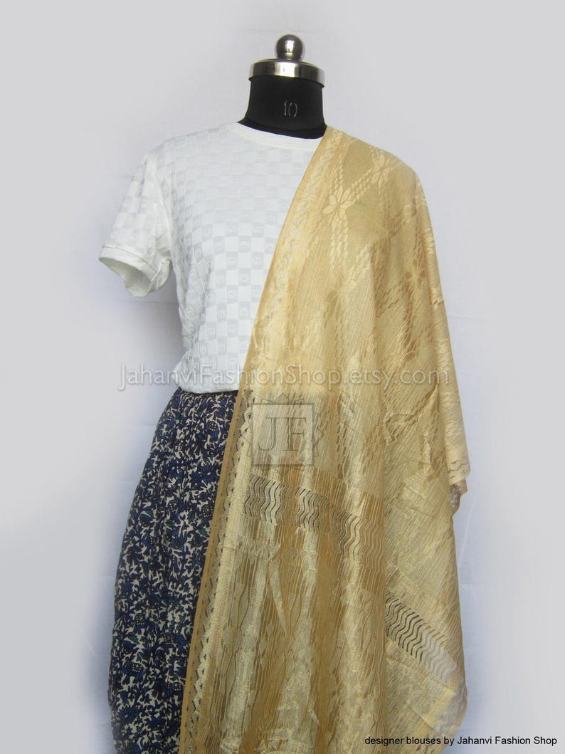 May include: A mannequin displays a white t-shirt, a navy blue floral skirt, and a gold-colored scarf. The scarf has a textured pattern and drapes over the mannequin's shoulder. The text "JahanviFashionShop.etsy.com" is visible.