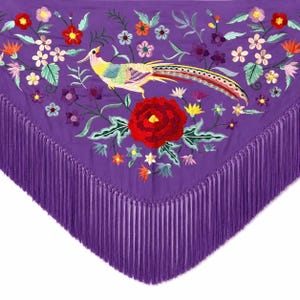 May include: A triangular purple shawl featuring intricate embroidery of a long-tailed bird and various colourful flowers including a large central red peony. The edges of the shawl are finished with long, matching purple fringe trim.