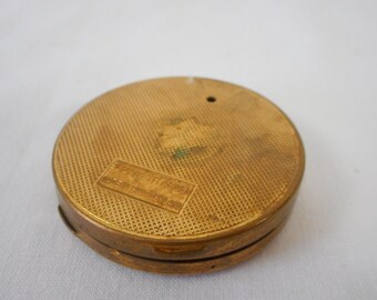 vintage Swiss small gold coloured metal compact