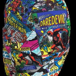 May include: A comic book-themed hat featuring panels from Marvel comics, including Iron Man, Spider-Man, and Daredevil. The hat's design incorporates vibrant colors and text bubbles, creating a dynamic and eye-catching accessory.