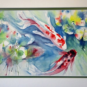 May include: Watercolor painting of three koi fish swimming in a pond with lily pads. The fish are red, white, and black with splashes of color in the background.