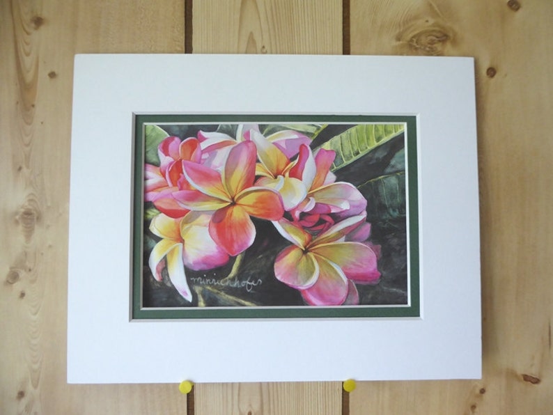 May include: A framed watercolor painting of pink and white plumeria flowers with green leaves. The artist's signature, "minnichoff", is visible in the bottom right corner.