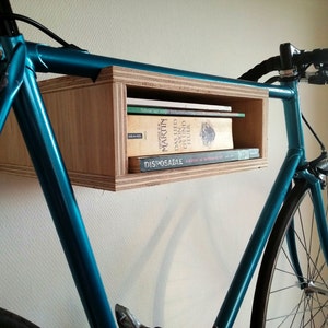 Basic wooden bike rack. Small bike storage cabinet. Wall mounted bike display bookshelf combination. Plywood.