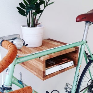 Basic oak wooden bike rack. Small bike storage cabinet. Wall mounted bike display bookshelf combination.