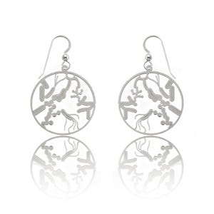 May include: Silver dangle earrings with a circular design featuring a delicate, intricate pattern of branches and leaves.