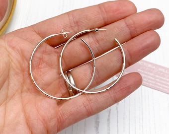 Large sterling silver hammered hoop earrings, handmade using recycled eco silver.