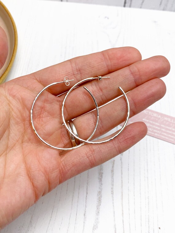 Large sterling silver hammered hoop earrings, handmade using recycled eco silver.
