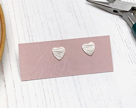 Recycled sterling silver heart stud earrings with hydrangea petal pattern, leaf imprint.