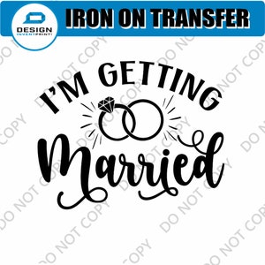 May include: Black and white iron-on transfer design that says "I'm Getting Married" with a stylised illustration of two interlocking rings and a diamond.