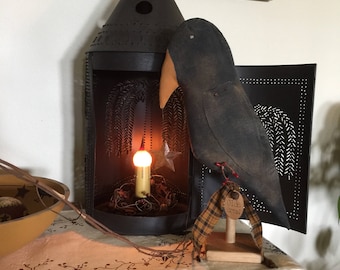 Large primitive crow on wooden stand