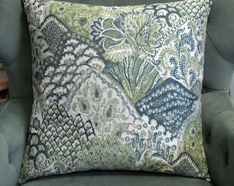 May include: A square throw pillow featuring a complex woven pattern in shades of sage green, forest green, and deep blue. The design consists of various geometric shapes, floral motifs, and intricate textures arranged in a patchwork-style layout.