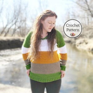 May include: A crochet sweater with a striped pattern in green, white, orange, brown, and green. The sweater has long sleeves and a v-neck. The text "Crochet Pattern" is visible in the image.