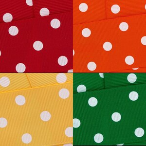 May include: Four different coloured ribbons with white polka dots. The ribbons are red, orange, yellow, and green.