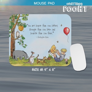 May include: A Winnie the Pooh themed mouse mat with a quote from Christopher Robin: "You are braver than you believe, stronger than you seem and smarter than you think." The mouse mat features Winnie the Pooh, Piglet, Tigger, Eeyore, and Christopher Robin. The mouse mat is 9 inches by 8 inches.