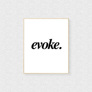 May include: A framed print featuring the word "evoke" in a bold, black, serif font centered on a white background. The frame is a thin, light brown colour. The background is a textured, off-white colour.