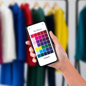 May include: A smartphone displaying a True Winter color palette grid on its screen. The grid features various shades of red, pink, purple, blue, green, yellow, and white. The text True Winter and Chromeria are visible on the white digital interface.