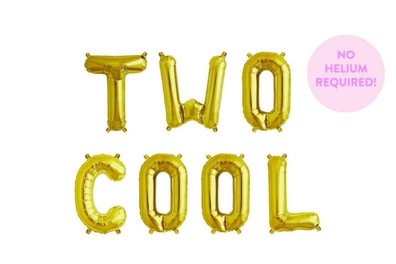 May include: Gold foil letter balloons spelling out "TWO COOL" with a pink circle balloon that says "NO HELIUM REQUIRED!"