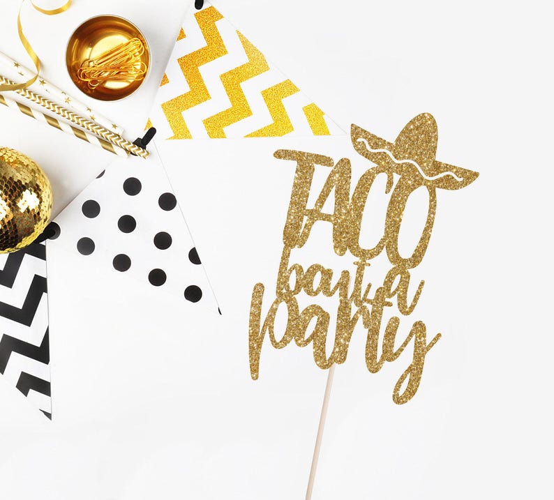 May include: Gold glitter cake topper with the text "Taco Bout a Party" and a sombrero.