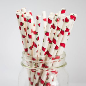 May include: A glass jar filled with white paper straws with a watermelon print. The jar is labeled "Bernardin".
