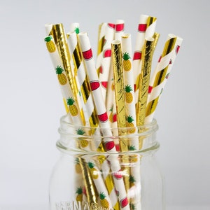 May include: A glass jar filled with a variety of gold and white striped paper straws with a pineapple and watermelon pattern. The jar is labeled "Bernardin".