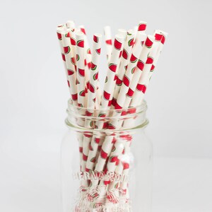 May include: A glass jar filled with white paper straws with a watermelon print. The jar is labeled "Bernardin Mason".