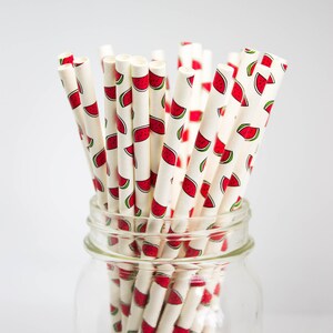 May include: A glass jar filled with white paper straws with a watermelon print. The jar has the word "BERNARDIN" printed on the side.