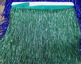 May include: Green and blue beaded fringe trim. The fringe is made of small, cylindrical beads that are strung together to create a long, flowing fringe. The fringe is perfect for adding a touch of elegance to any project.